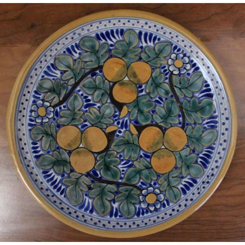 Hand-painted Talavera Plate D4 with traditional Mexican floral and fruit design on wood background