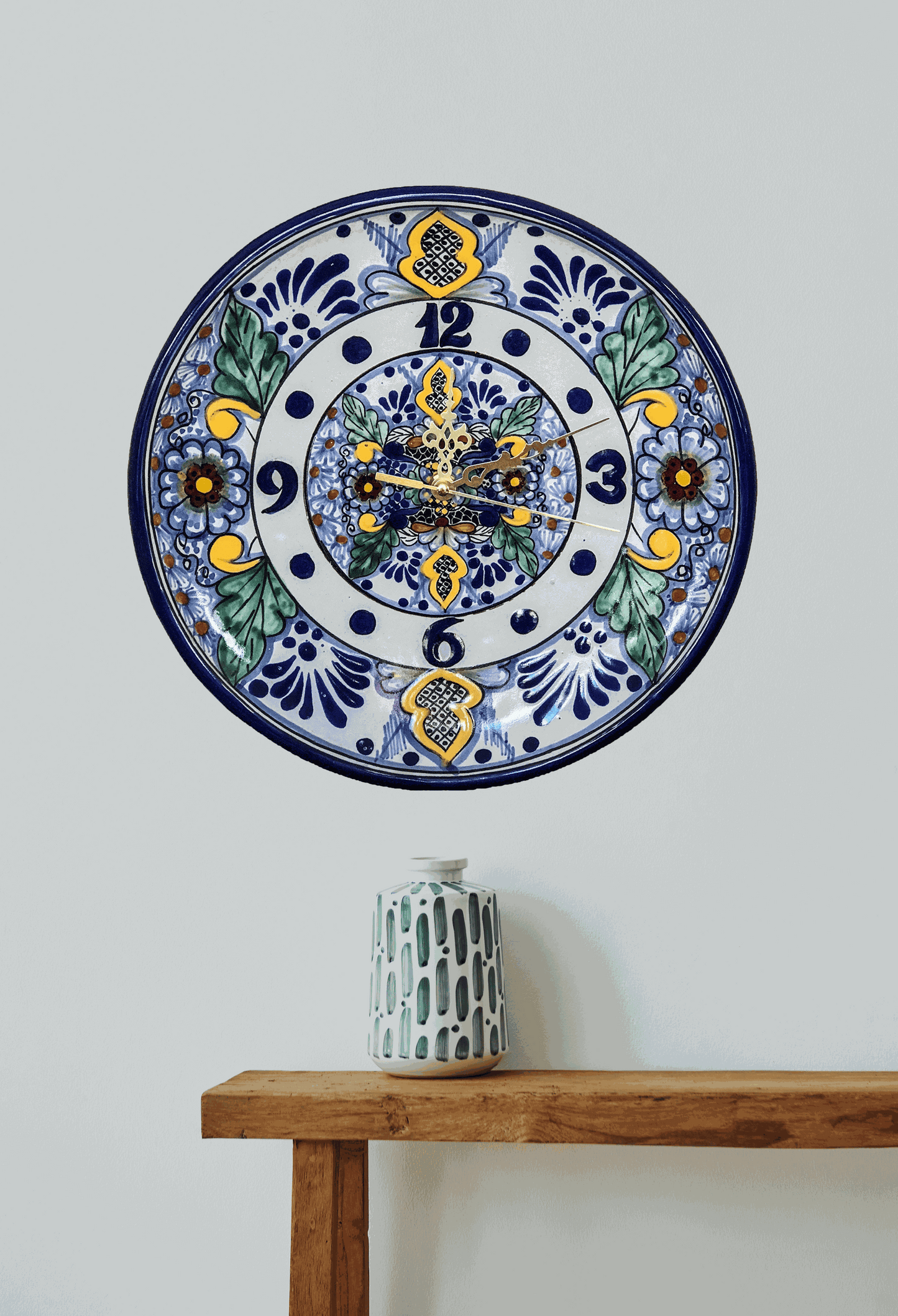 Handcrafted 30 cm Talavera clock with traditional blue, yellow, and green floral patterns from La Corona workshop in Mexico.