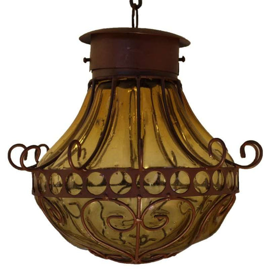 Blown glass pendant lamp with amber-colored glass and rustic metal frame in Mexican craftsmanship style