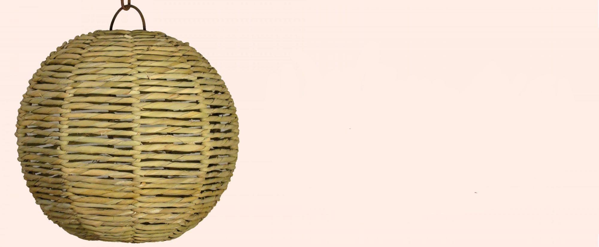 Woven spherical lantern on a beige background