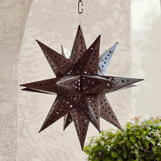 Handcrafted Punched Tin Star Pendant Lamp with intricate Mexican artisan patterns illuminating warm, rustic décor